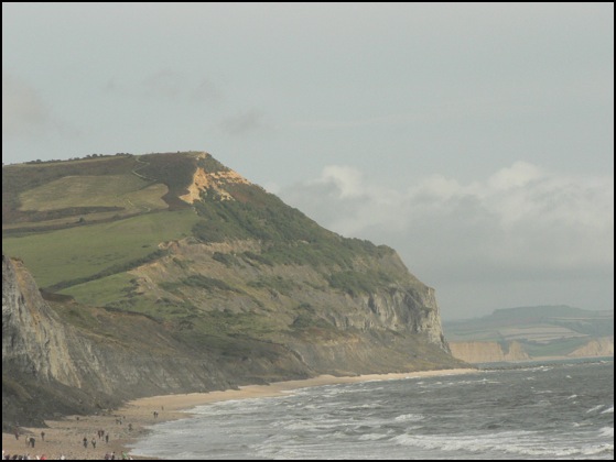 2 people walking on beach. people walking the each